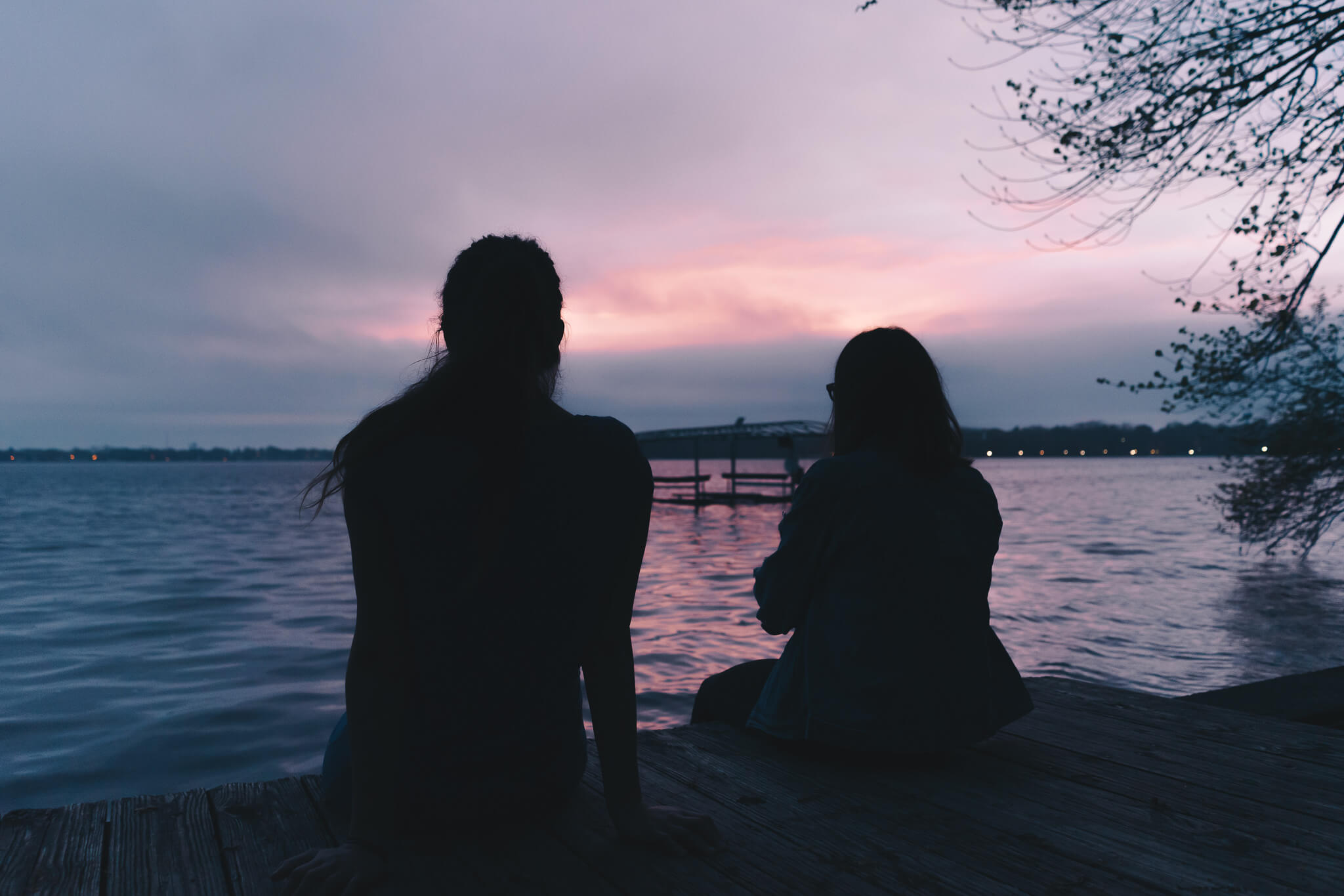 Helen Cramer and Kathryn Keur photographed sitting on the house’s East shore dock on the night of our arrival.
